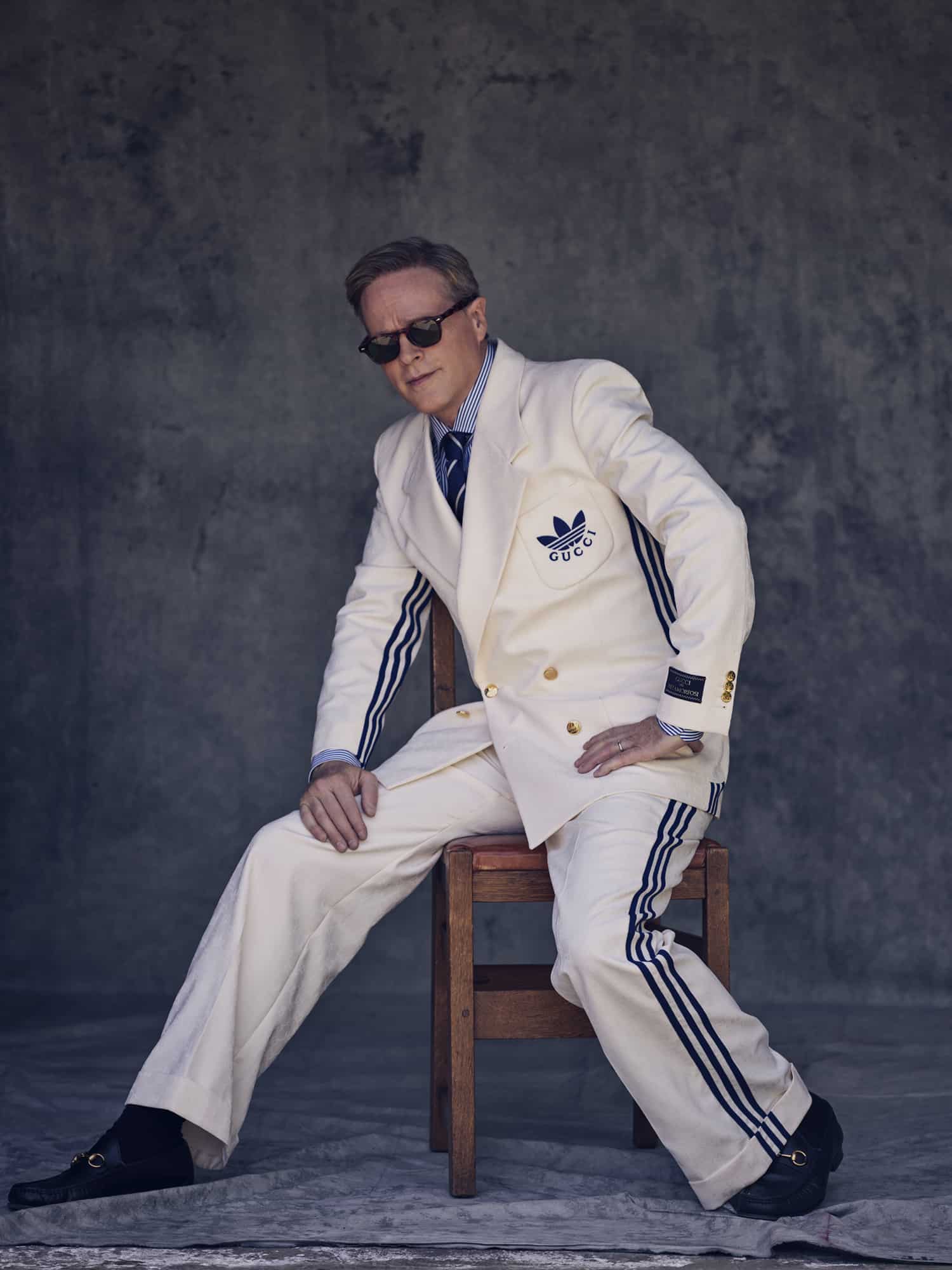 Cary wears ivory monogrammedand Adidas stripe suit, black leather loafers, by GUCCI. Striped shirt and tie by RALPH LAUREN. Sunglasses by JACQUES MARIE MAGE. // 📸 : Kurt Iswarienko