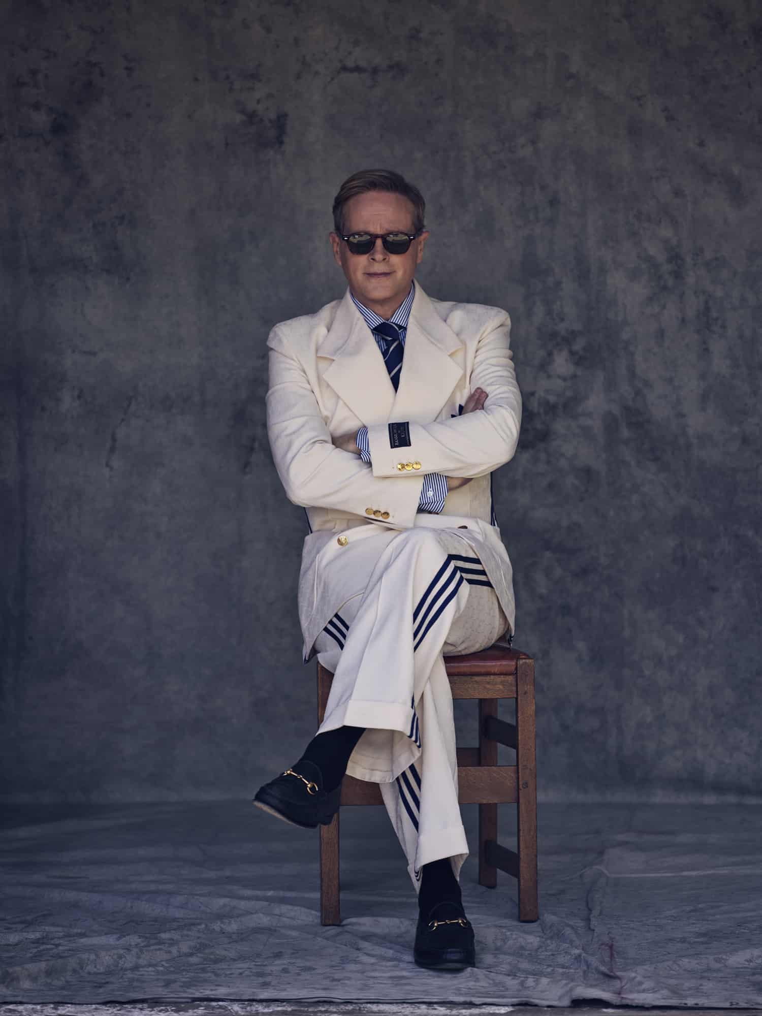 Cary wears ivory monogrammed and Adidas stripe suit, black leather loafers, by GUCCI. Striped shirt and tie by RALPH LAUREN. Sunglasses by JACQUES MARIE MAGE. // 📸 : Kurt Iswarienko