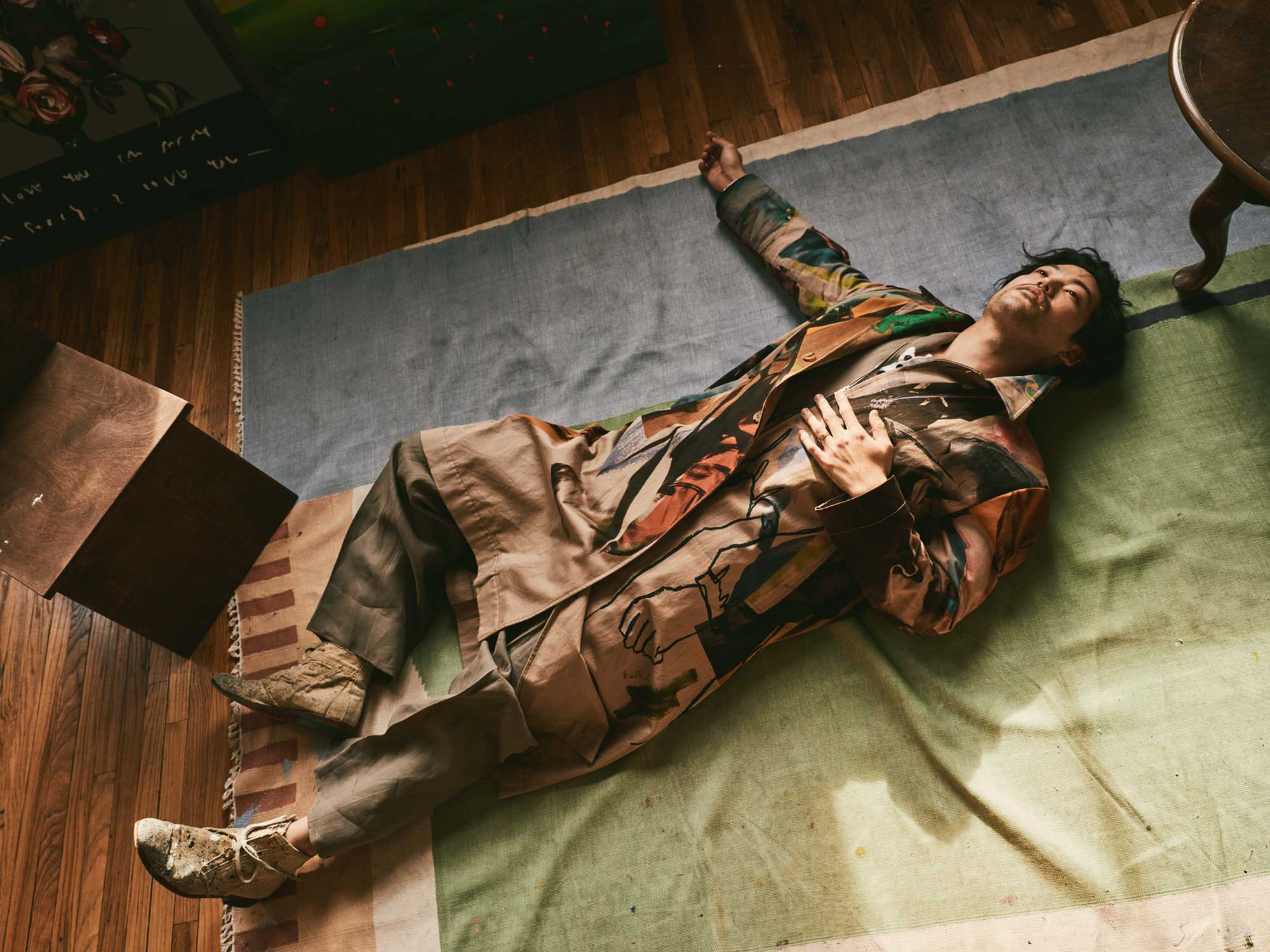 Joseph wears PAUL SMITH painter print cotton overcoat. ZEGNA taupe linen jumpsuit. GREG LAUREN white button up long sleeved cotton jersey tee; tan canvas lace up boots. //📸 : Beau Grealy